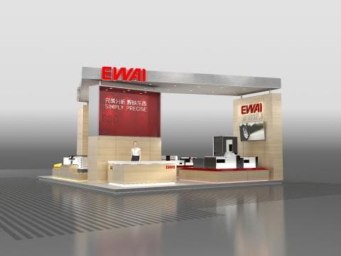 這張展覽攤位的照片是 EWAI 公司的展位，展位上有紅色的招牌和公司標語，以及一個櫃臺和一些展示品。