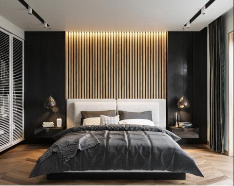 這張照片是一間臥室，房間的重點是中間那張舒適的雙人床。床頭板是白色的，床罩是深灰色的，看起來很柔軟舒適。床頭板後面的牆壁上有木條，給臥室添加了一份溫馨的木質質感。