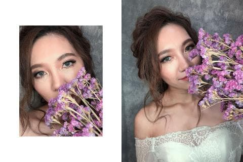 這張照片是一位美麗的女性，她用一束紫色的花遮住了臉，只有眼睛露出來。