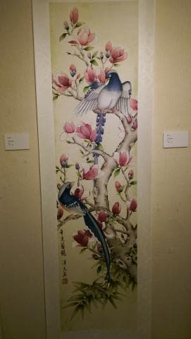 這張「花鳥」的照片是一幅中國傳統的繪畫，描繪了兩隻鳥兒在繁盛的樹枝上棲息，樹枝上開滿了豔麗的花朵。