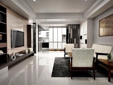 這張照片是一間現代風格的客廳，客廳裡有一個大型的電視牆，電視牆上掛著一臺尺寸不小的電視機，電視牆下方還有電視櫃，看起來非常舒適且具現代感。