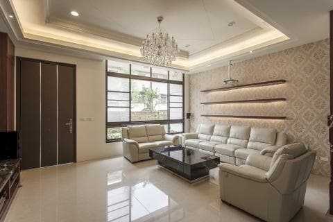 這張「客廳」的照片是一個現代化的客廳，有沙發、茶几、落地窗和壁燈。