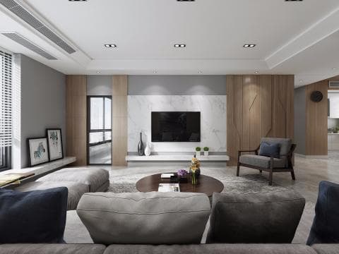 這張「客廳」的照片是一個現代化的家居設計，以簡約的色調和舒適的傢俱為主。照片中有一個舒適的沙發，配有抱枕和毛毯，旁邊還有一個茶几，放著一些裝飾品，顯得溫馨舒適。牆壁上掛著兩幅畫，增添了一份藝術氣息，房間的整體色調以灰白色為主，給人一種乾淨清爽的感覺。