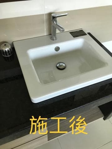 這張照片是裝修後，黑色的檯面跟白色的洗手台看起來很乾淨整潔。