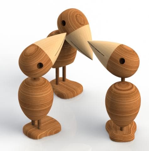 這張照片是三隻木頭做成的鳥，牠們的喙互相接觸，形成一個圓圈。
