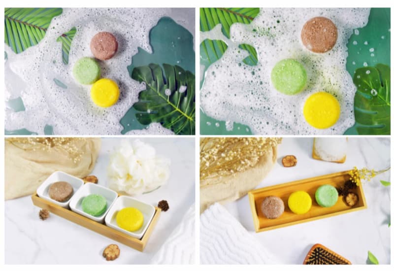 這張「洗髮皂」的照片是三種不同顏色的洗髮皂，分別是棕色、綠色和黃色。它們放在一個木質的託盤上，旁邊還有泡泡和綠色植物。