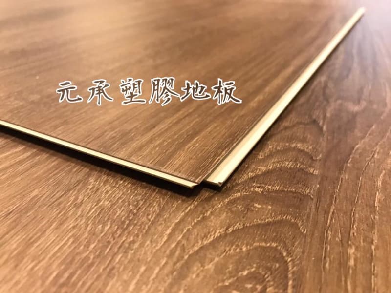 這張照片是一塊木紋地板，地板上有「元森塑膠地板」的字樣。