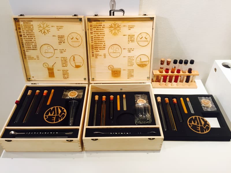 這張照片是三盒木製的調酒工具組，每個盒子都有不同的調酒配方，裡面裝著各種酒類和配料，以及一個小巧的攪拌器，讓您可以輕鬆製作美味的雞尾酒。