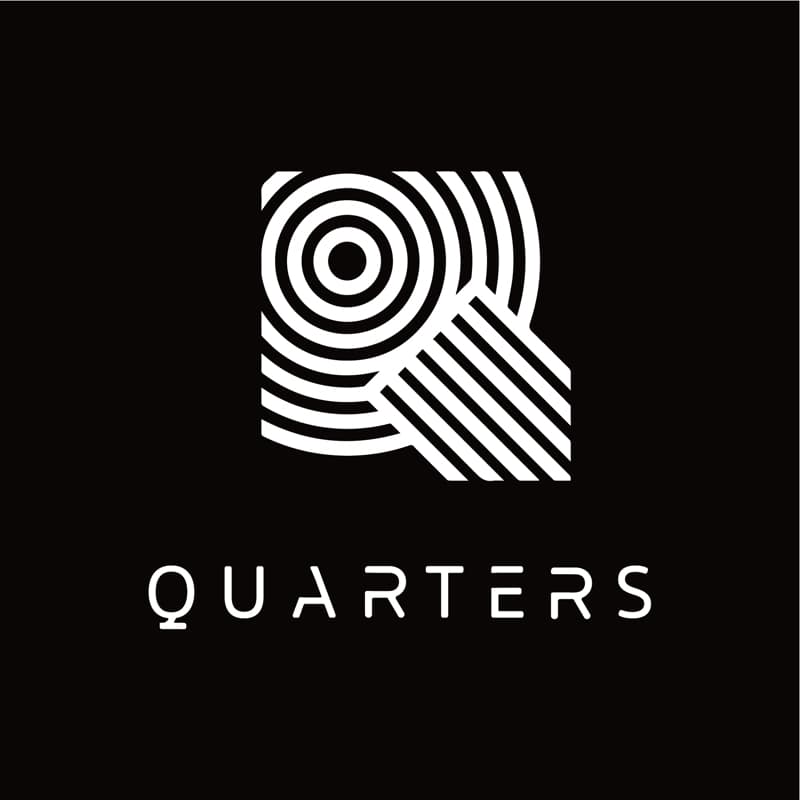這張照片是一個以幾何線條構成的字母 Q 圖案，下方寫著 QUARTERS 的字樣。