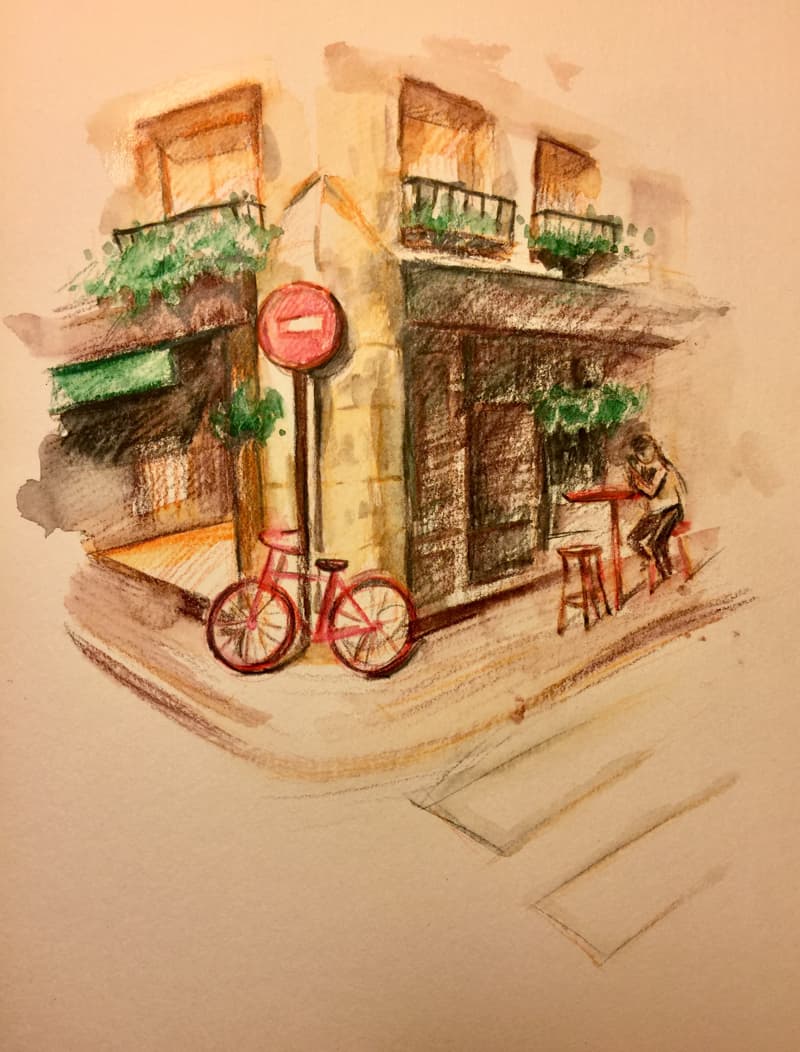 這張照片是一輛停在建築物外的紅色自行車。自行車輪子是紅色的，車身是黑色的。自行車停在建築物門口的街道上。