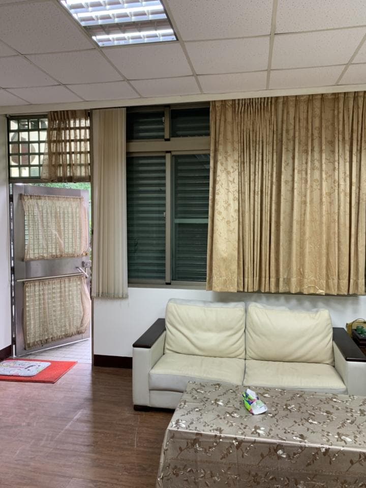 1) 照片顯示一個客廳,有一個沙發、茶几、窗戶和門