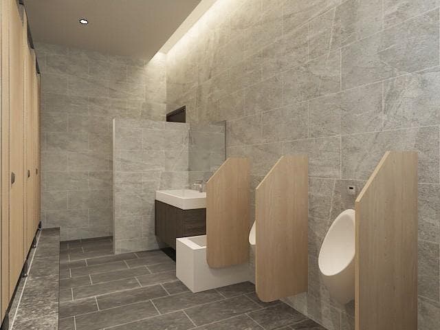 1) 這是一張公共廁所的圖片,裡面有三個小便池,牆壁和地板都是灰色和米色的瓷磚