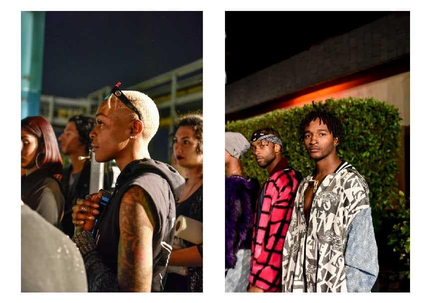 這張「一群人站在一起」的照片是,畫面左邊有五個人,其中一個女生穿著黑色背心,另外四個人穿著比較正式的服裝;畫面右邊有三個男生,其中一個穿著紅色的外套,另外兩個穿著比較休閒的服裝。