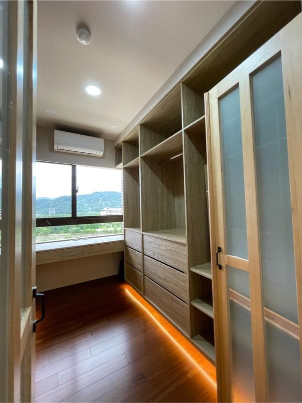 這張照片是一間臥室衣帽間,最重要的是衣帽間的燈光設計,透過暖色調的燈光,照亮了整個衣帽間,讓空間更顯溫馨舒適。