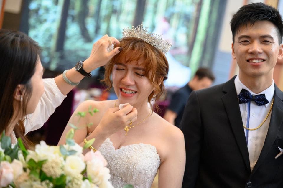 這張「婚禮」的照片是新娘正在化妝,新郎則站在一旁微笑。