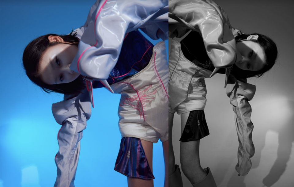 這張照片是一個穿著時尚服裝的女性,她的頭髮很短,她正低頭看著鏡頭。