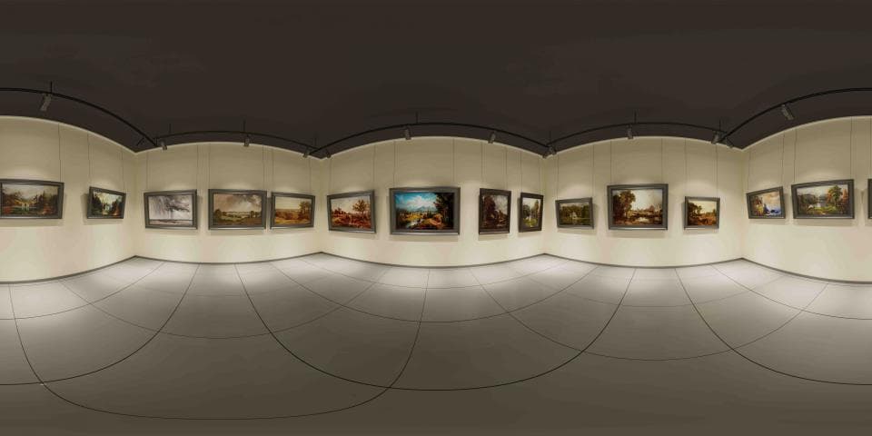 這張照片是一個美術館的展覽空間,最重要的是牆上懸掛的許多畫作,這些畫作都裝在精美的畫框裡,展現出各種不同的藝術風格和主題。