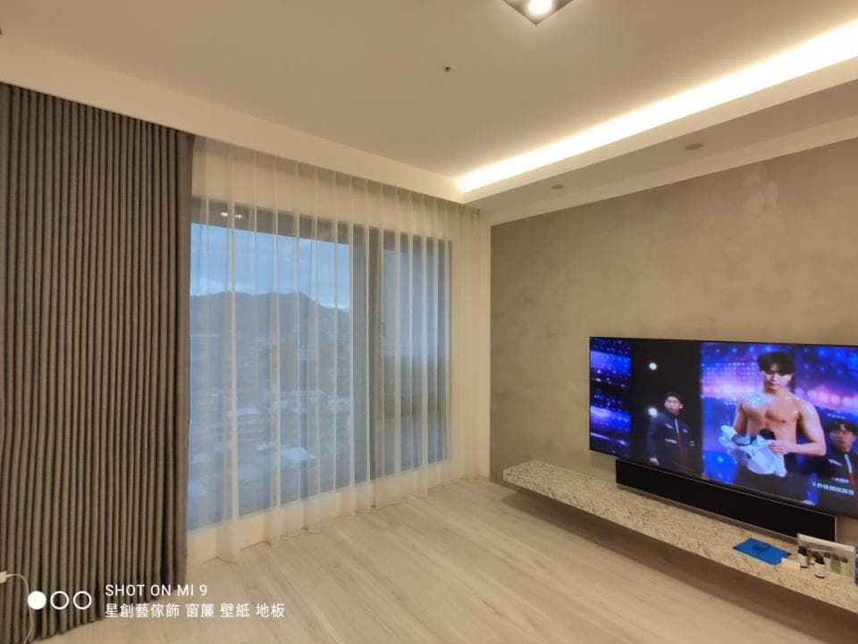 1) 這張照片展示了一個客廳的角落,裡面有沙發、窗戶、電視和桌子