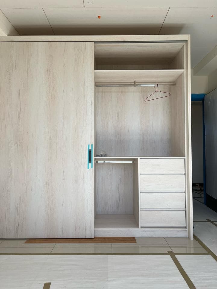 1) 照片顯示一個木製衣櫃,左側有滑門,右側有固定層板及抽屜