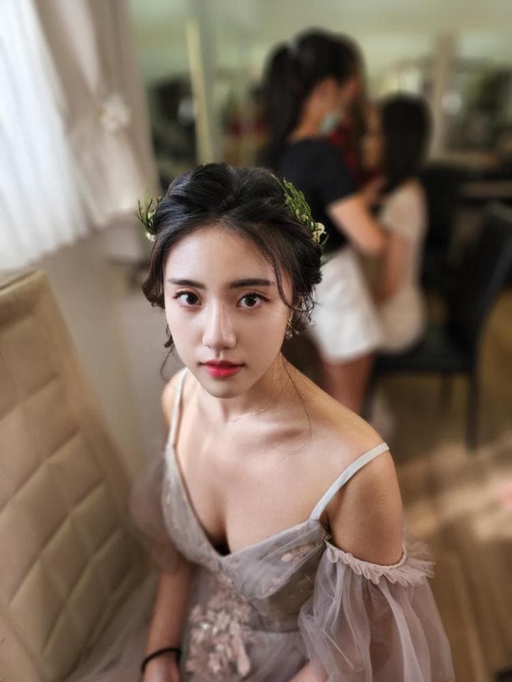 這張「婚禮」的照片是一位穿著蕾絲禮服的新娘,她戴著花環,並看著鏡頭。