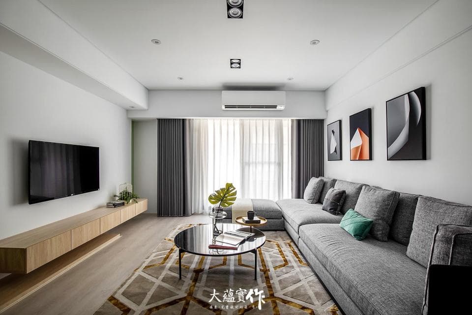 這張照片是現代化的客廳,最重要的是牆上掛著三幅抽象畫,讓空間顯得更為藝術與時尚。