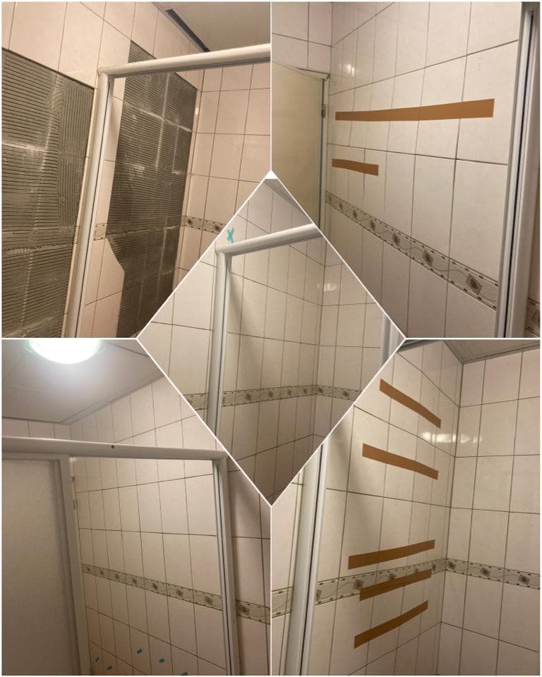 這張照片是一間浴室,其中最重要的是牆上貼著的四條膠帶。