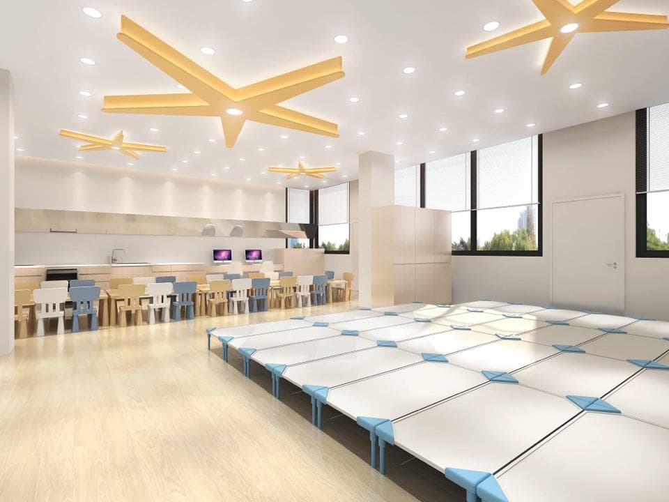 這張「教室」的照片是一個明亮的空間,配有木製桌子和椅子,以及一個藍色和白色的地板。