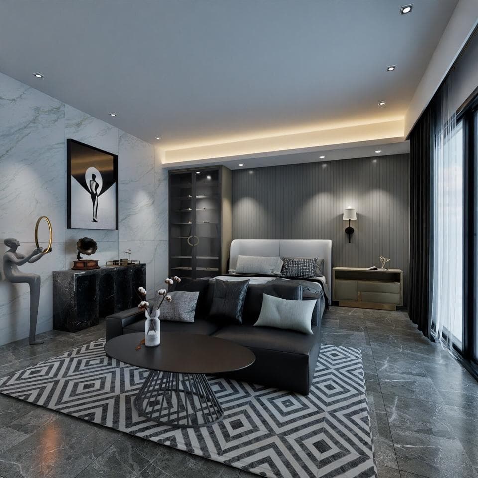 這張照片是一個現代化的臥室,有著黑色的皮革沙發,一個金屬桌,以及一個帶有黑色床單的雙人床。床頭板是白色的,並且房間裡有許多黑色的傢俱。