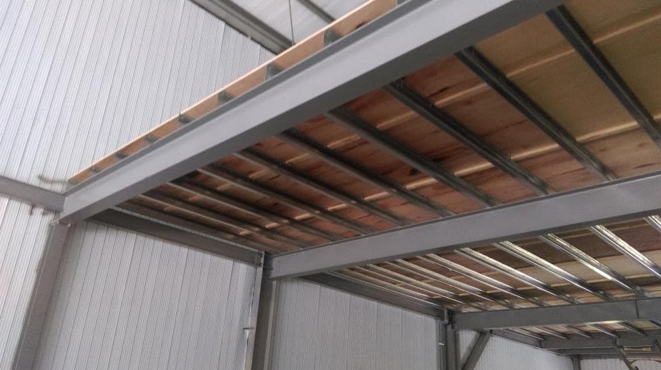 1) 照片顯示一個鋼鐵結構的屋頂,由許多鋼樑支撐,並以木板作為頂板