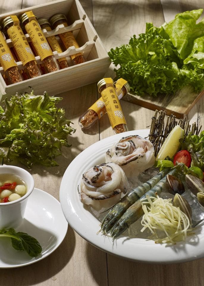 這張「擺滿海鮮的盤子」的照片是,盤子裡放著蝦子、貝類和魷魚,看起來非常新鮮美味。