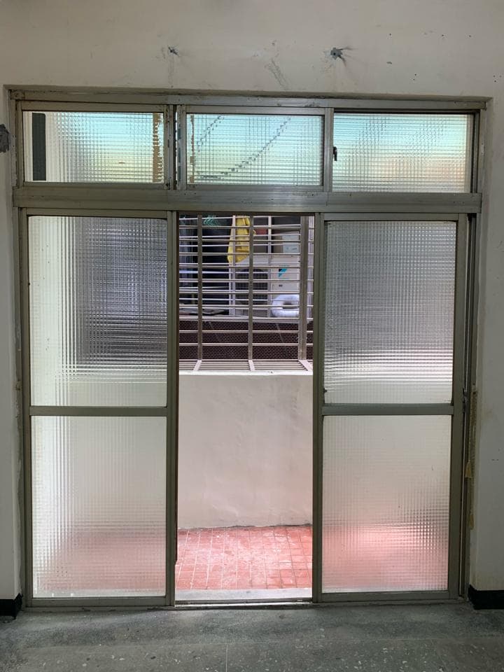1) 照片中展示了一扇玻璃門,門上帶有金屬框架,分成三格