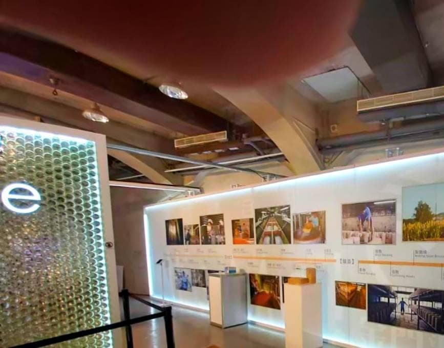 這張照片是一間展覽館的內部,照片中最顯眼的是展牆上排列整齊的展品照片。牆上裝置了燈光,使展品照片更加醒目。