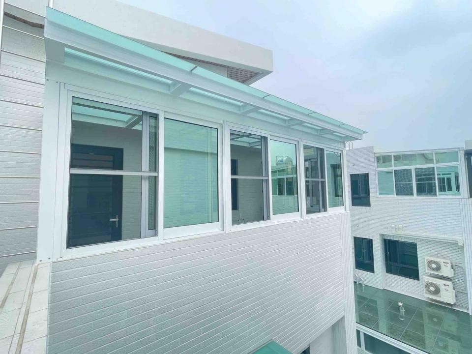 這張「陽臺」的照片是一間帶有玻璃屋頂的陽臺,陽臺上有許多窗戶,陽臺上還有一扇門,通往室內。