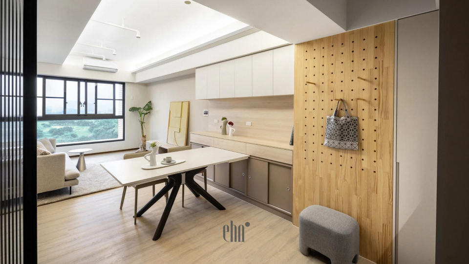 這張照片是展示了一個木質掛牆板,上面有許多孔洞,可供放置物品,並設有掛鉤,可供懸掛包包或其他物品。牆板採用自然色調的木板,呈現出簡約自然的風格。