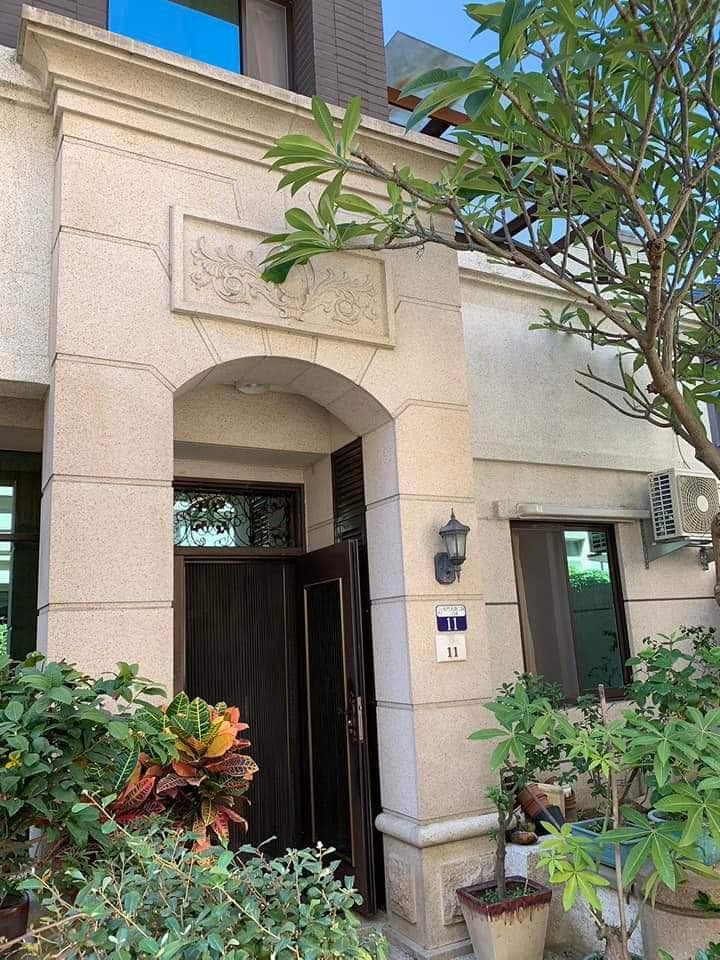 這張照片是一棟建築物的正面,最顯眼的特徵是入口處的大門,門上裝飾著精美的雕花,給人一種典雅的感受。