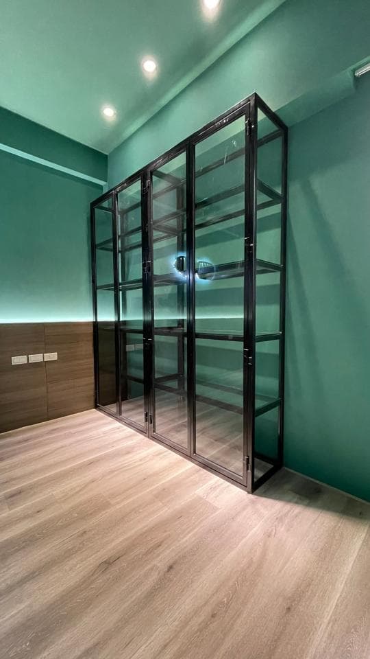 1) 照片展示了一個房間,房間裡有一件黑色金屬和玻璃材質的書櫃