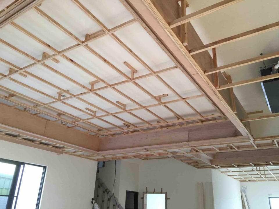 1) 照片顯示一個木質天花板的結構,由許多木條交叉排列組成,呈現網格狀