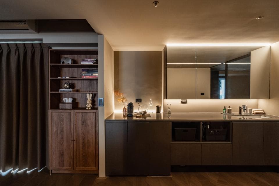 1) 照片顯示一個現代的廚房,裡面有木質櫥櫃、一個水槽和一個鏡子