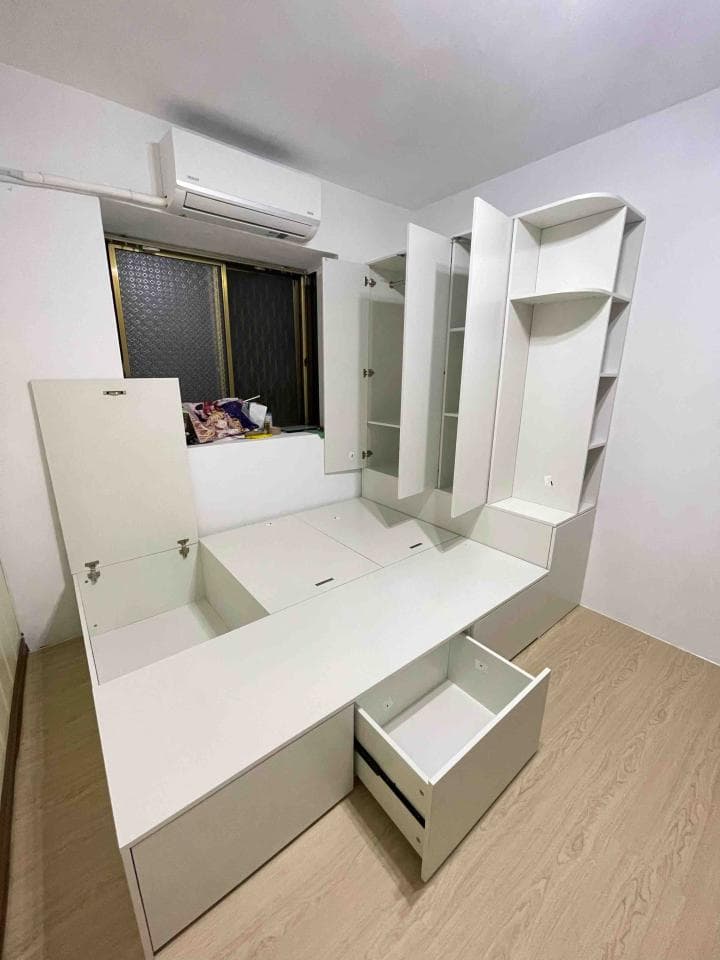 這張照片是一個現代化臥室,最顯眼的是一個白色床架,它擁有巧妙的設計,配備多個抽屜和櫃子,可滿足收納需求。