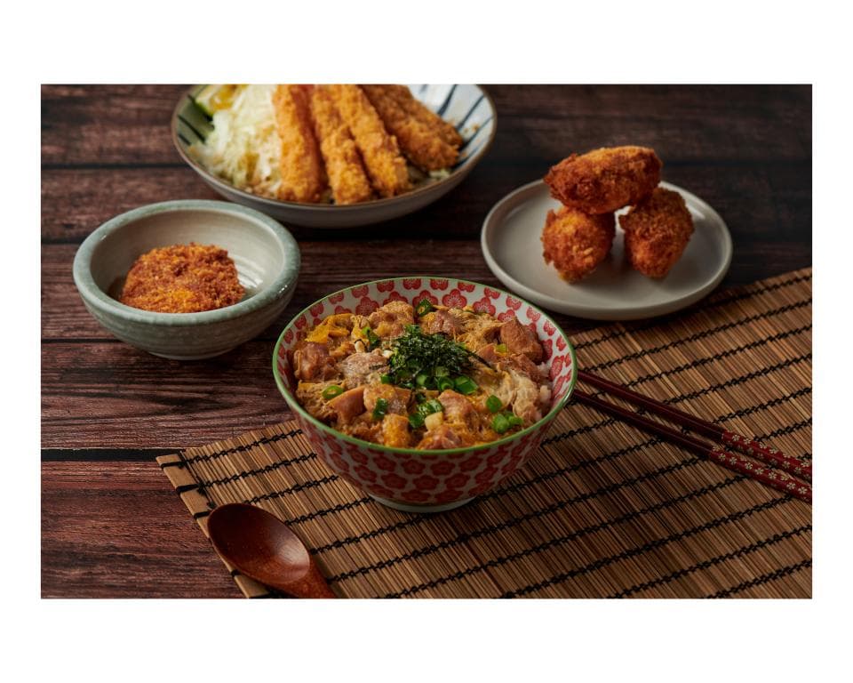 這張照片是一碗日式蓋飯,裡面有肉、蛋和蔬菜,看起來很美味。