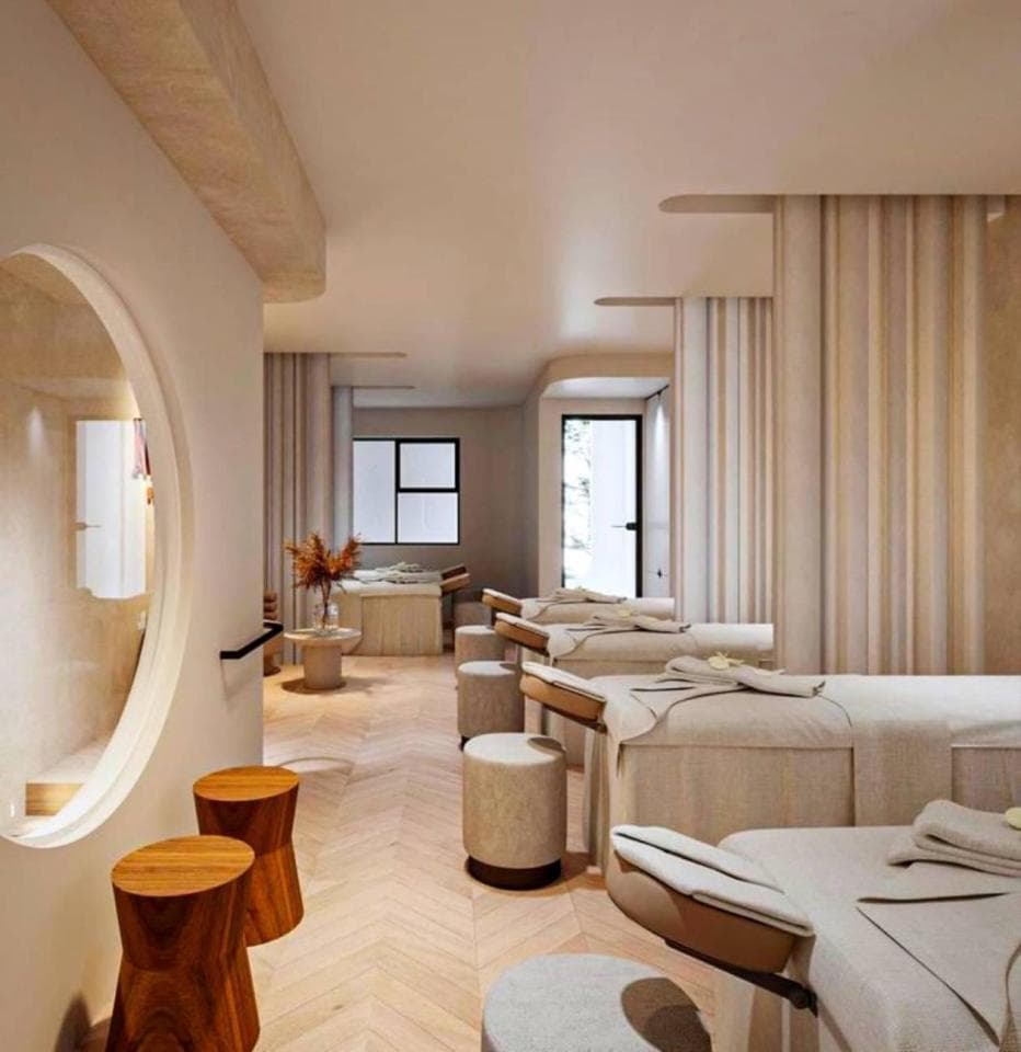 這張照片是一家現代化的水療中心,裡面的床鋪看起來非常舒適,適合享受放鬆的按摩體驗。