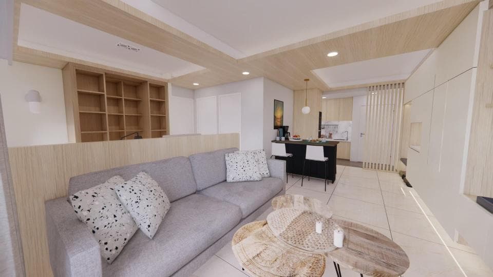 這張照片是一個現代化的客廳,有一個舒適的灰色沙發和一個木製的咖啡桌,旁邊擺放著一些裝飾性的枕頭。