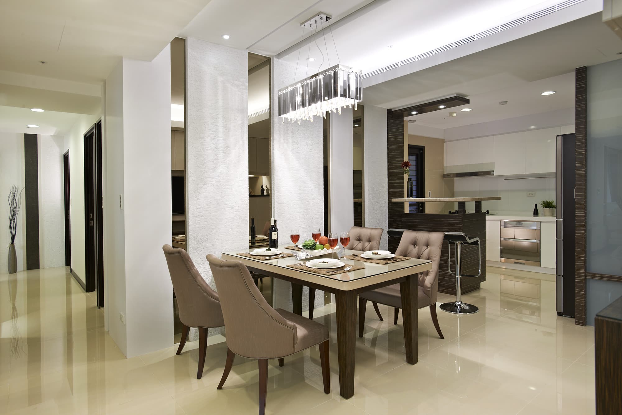 這張「現代化餐廳」的照片是一張木質餐桌和四張椅子,房間的中心擺放著一盞水晶燈。餐桌上有花瓶和酒杯。