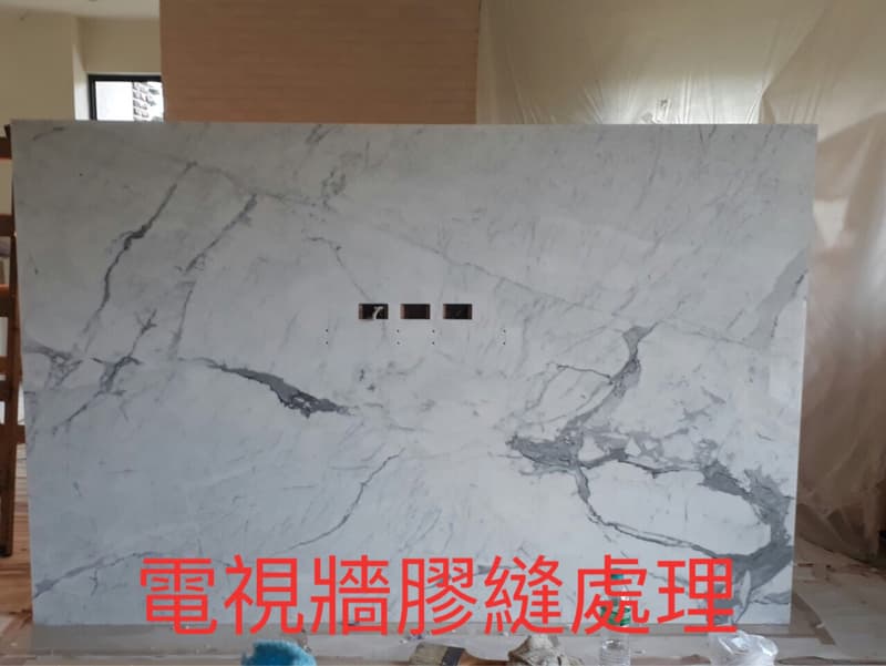 這張照片是一面白色大理石牆,上面有明顯的天然紋理,牆面看起來很乾淨,呈現出高級質感。